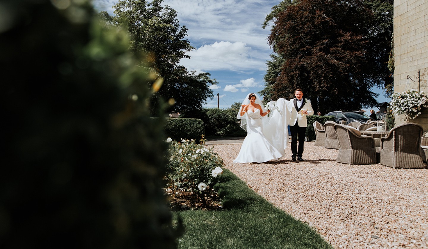 couple walking together through pebbled walkway at Falcon Manor